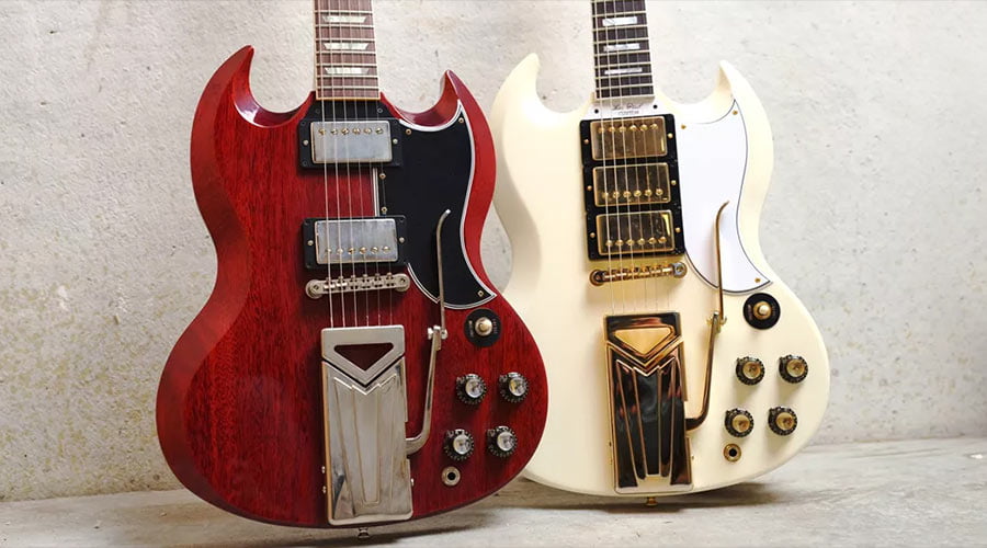 Gibson SG guitars in cherry and the other in white.