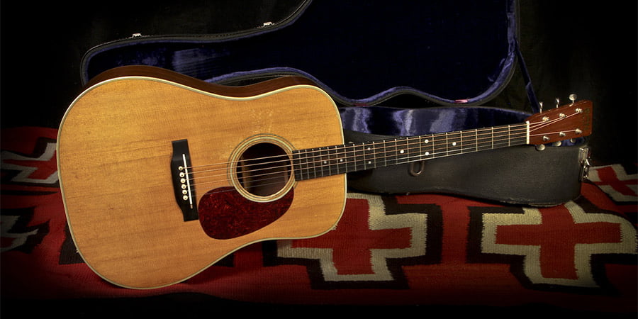 A 1971 Martin D-28 acoustic guitar with its original case.