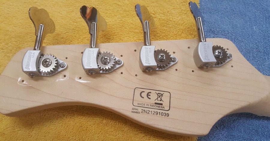 Extra holes drilled into the back of the headstock